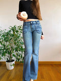Jeans chiari vintage anni 90 svasati. Tasche frontali vita bassa